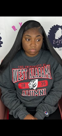 a black woman wearing a grey sweatshirt with the word west alabama on it